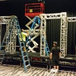 truss structures and scissor lift at event